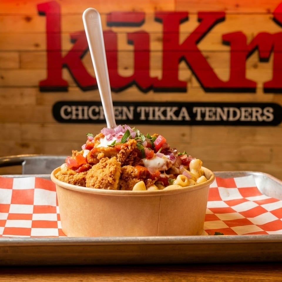 Kukri Chicken Tikka Tenders bowl with mac and cheese, toppings, and a white spoon.